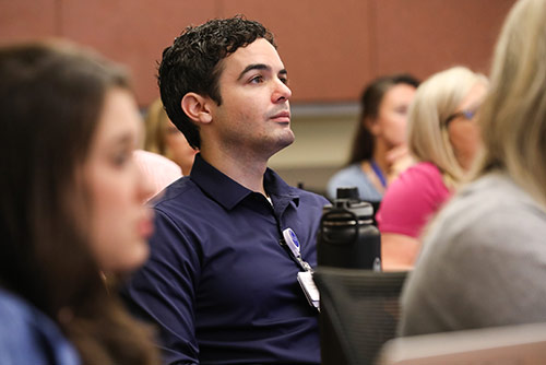 a male nursing student sitting in a classroom